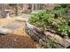 Beautiful backyard with stone steps, retaining wall, small grass area, and mature landscaping at 3572 Dexter Way, Marietta, GA 30062