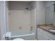 Neutral bathroom with tiled shower-tub combination and granite-topped vanity at 3572 Dexter Way, Marietta, GA 30062