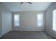 Carpeted bedroom featuring a double closet, neutral walls, and two windows at 3572 Dexter Way, Marietta, GA 30062