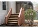 Exterior view of stairs with wood railing leading to home's sunroom and main level at 3572 Dexter Way, Marietta, GA 30062