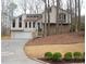 Inviting home exterior with attached garage, beautiful curb appeal and mature trees at 3572 Dexter Way, Marietta, GA 30062