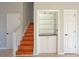 Staircase view including a display shelf with glass shelves and built-in cabinet at 3572 Dexter Way, Marietta, GA 30062