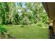 Expansive backyard with lush green lawn, mature trees, and natural surroundings at 3697 Wisteria Sw Ln, Atlanta, GA 30331