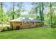 Back view of a brick home with a spacious and well-manicured backyard at 3697 Wisteria Sw Ln, Atlanta, GA 30331