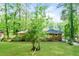 View of the backyard with lawn and trees behind the house at 3697 Wisteria Sw Ln, Atlanta, GA 30331
