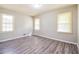 Bright bedroom featuring neutral paint, ample natural light, and luxury vinyl flooring at 3697 Wisteria Sw Ln, Atlanta, GA 30331