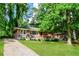 Inviting brick home featuring a well-maintained front yard and a cozy front porch at 3697 Wisteria Sw Ln, Atlanta, GA 30331