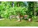 Charming brick home with a lush front yard and mature trees, offering a serene setting at 3697 Wisteria Sw Ln, Atlanta, GA 30331