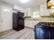 Functional kitchen boasts a black gas range, neutral counters, and white cabinets at 3697 Wisteria Sw Ln, Atlanta, GA 30331
