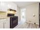 Functional kitchen boasts a black gas range, neutral counters, and white cabinets at 3697 Wisteria Sw Ln, Atlanta, GA 30331