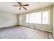 Bright living room with ceiling fan, luxury vinyl flooring, and ample natural light at 3697 Wisteria Sw Ln, Atlanta, GA 30331