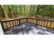Back deck with black railing overlooking a wooded backyard at 381 Fleming Ct, Jonesboro, GA 30238