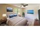 Bright bedroom featuring a ceiling fan, neutral walls, plush carpet, and a large window letting in plenty of natural light at 381 Fleming Ct, Jonesboro, GA 30238