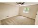 Clean, carpeted bedroom featuring a ceiling fan, neutral walls, and a large window letting in plenty of natural light at 381 Fleming Ct, Jonesboro, GA 30238