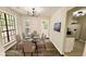 Dining room featuring large windows, table with seating, and a modern chandelier at 381 Fleming Ct, Jonesboro, GA 30238