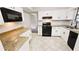 Kitchen featuring white cabinetry, granite counters, and black appliances at 381 Fleming Ct, Jonesboro, GA 30238