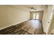 Spacious room with wood-look flooring, neutral walls, ceiling fan, and glass doors to the outdoor patio at 381 Fleming Ct, Jonesboro, GA 30238