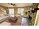 Staged living room with a stone fireplace, rug, couch, and chair at 381 Fleming Ct, Jonesboro, GA 30238