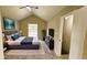 A staged bedroom featuring a queen bed, dresser, tv, and ample light at 381 Fleming Ct, Jonesboro, GA 30238