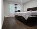 Comfortable bedroom with a queen-size bed, wood floors, and a large window at 5655 Lake Forrest Dr, Atlanta, GA 30342