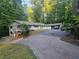Spacious single-Gathering home with a brick driveway and attached garage in a wooded setting at 5655 Lake Forrest Dr, Atlanta, GA 30342