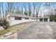 Charming single story brick home with an attached two car garage and long driveway at 5655 Lake Forrest Dr, Atlanta, GA 30342