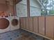 Laundry room with visible washer and dryer units, unfinished walls, and blue vinyl flooring at 5655 Lake Forrest Dr, Atlanta, GA 30342