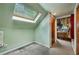 Unique attic space with a skylight, neutral paint, and hardwood door frames at 725 Brown Pl, Decatur, GA 30030
