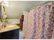 Bathroom with marble countertop vanity and floral patterned shower curtain at 725 Brown Pl, Decatur, GA 30030