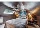 Attic bedroom featuring unique ceiling, fan, skylight, and neutral decor at 725 Brown Pl, Decatur, GA 30030
