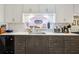 Well-lit kitchen with stone countertops, modern appliances, and ample storage space at 725 Brown Pl, Decatur, GA 30030