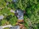 Aerial view of the home nestled among mature trees with a patio and long driveway at 1676 Grove Park Way, Decatur, GA 30033