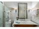 Bathroom featuring a marble countertop, patterned tiling, and contemporary sconces at 1676 Grove Park Way, Decatur, GA 30033