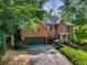 Stately brick home with a well-manicured lawn, mature trees, and an attached two-car garage at 1676 Grove Park Way, Decatur, GA 30033