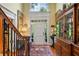 Bright foyer showcases a soaring transom window, hardwood floors, and elegant details throughout at 1676 Grove Park Way, Decatur, GA 30033