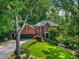 Stately brick home with mature landscaping and a well-manicured front yard offers great curb appeal at 1676 Grove Park Way, Decatur, GA 30033