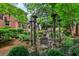 A stone gazebo provides an outdoor seating area surrounded by lush greenery and beautiful landscaping at 1676 Grove Park Way, Decatur, GA 30033