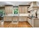 Spacious kitchen boasts custom cabinets, marble countertops, and a premium Wolf range at 1676 Grove Park Way, Decatur, GA 30033
