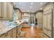 Open concept kitchen with marble counters, premium appliances, and ample cabinet storage at 1676 Grove Park Way, Decatur, GA 30033