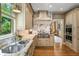 Gourmet kitchen offering marble countertops, custom range hood, and stainless steel appliances at 1676 Grove Park Way, Decatur, GA 30033