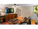 Comfortable living room featuring entertainment center, TV, and access to hallways and closets at 1676 Grove Park Way, Decatur, GA 30033