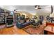 Spacious living room area with a large sofa, treadmill, bookcase, and sports memorabilia at 1676 Grove Park Way, Decatur, GA 30033