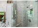 Marble-tiled shower with glass door, mosaic tile detail, and chrome fixtures in a luxurious bathroom at 1676 Grove Park Way, Decatur, GA 30033