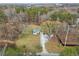 Aerial view of charming home on spacious lot surrounded by mature trees, with a winding driveway at 1892 Buford Dam Rd, Buford, GA 30518