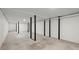 Unfinished basement with painted walls and black support beams is ready to be customized at 1892 Buford Dam Rd, Buford, GA 30518