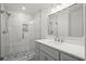 Modern bathroom featuring a glass shower, tile, gray vanity, and a large mirror at 1892 Buford Dam Rd, Buford, GA 30518