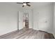 Bright bedroom with ceiling fan and wood-look floors showcases the spacious layout and freshly painted walls at 1892 Buford Dam Rd, Buford, GA 30518