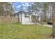 Beautifully renovated single-Gathering home featuring fresh exterior paint, a small porch, and manicured lawn at 1892 Buford Dam Rd, Buford, GA 30518