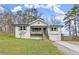 Charming home with a well-manicured lawn, garage, and inviting porch, offering great curb appeal at 1892 Buford Dam Rd, Buford, GA 30518