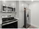 Modern kitchen featuring stainless steel appliances, sleek countertops, and stylish gray cabinets at 1892 Buford Dam Rd, Buford, GA 30518